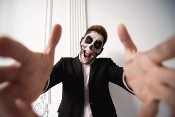 Skull make up portrait of young man. Halloween face art