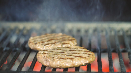 Beef or pork meat barbecue burgers for hamburger prepared grilled on bbq fire flame grill