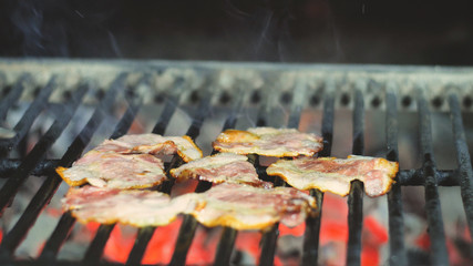 Eight slices of bacon are grilled in the restaurant's kitchen, ingredients for burgers salads