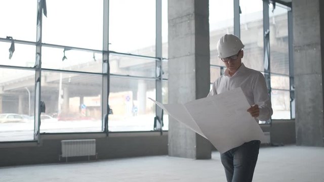 Architect or engineer working, browsing building project indoor of construction site with blueprint plan. businessman worker, man male construction engineers or architects working people