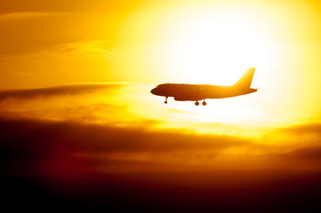 Fototapeta na wymiar Passenger Aircraft Silhouette With Sun Shining Behind
