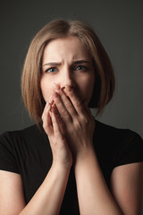 Portrait of the puzzled young woman.