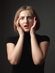 Scared young woman. Studio portrait