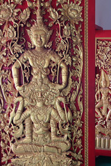 bas-relief on a wall in a buddhist temple (Wat Pan Ping) in chiang mai (thailand)