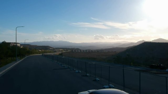 Aerial shot as Dodge Challenger drives off into the sunset.
