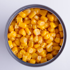 Canned corn in a iron can on white background