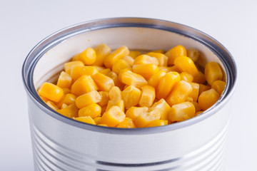 Canned corn in a iron can on white background