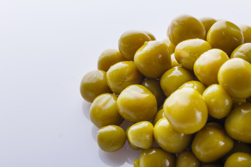 canned green peas on a white acrylic background