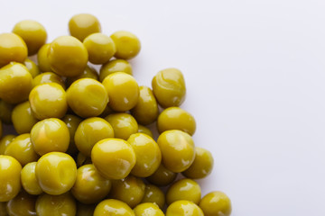 canned green peas on a white acrylic background
