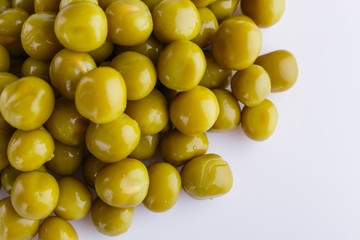 canned green peas on a white acrylic background