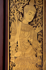 decorated door (divinity) in a buddhist temple (Wat Phra Sing) in chiang mai (thailand)
