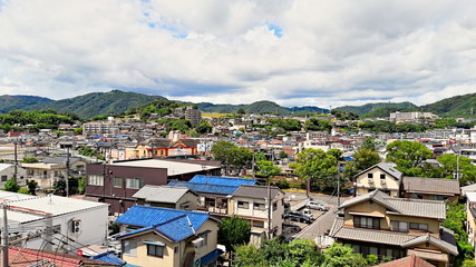 Fukuyama, Japan - August 29, 2016: Aerial view of the city of Fukuyama in a summer afternoon with hills on the background