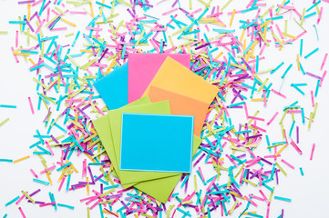 colorful confetti and party invites on a white background