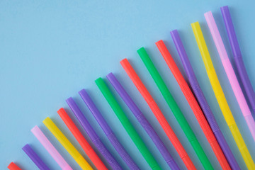 Fototapeta premium Multicolored Tubules for a cocktail on a blue background.