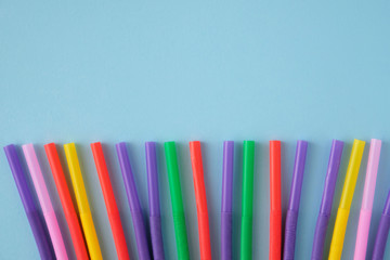 Fototapeta premium Multicolored Tubules for a cocktail on a blue background.