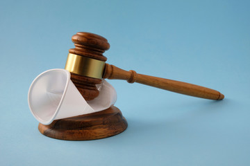 Judges gavel breaks plastic cup. Concept of  law on  prohibition of disposable tableware.