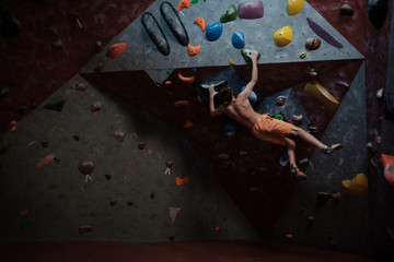 Athletic man practicing in a bouldering gym © Nejron Photo