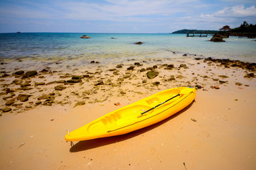   A bright yellow kayak on the beach