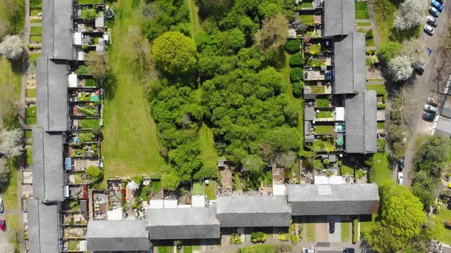 Top down view ove ra residential area comprising of mid terrace houses with woodlands at the rear in Basildon on a sunny day