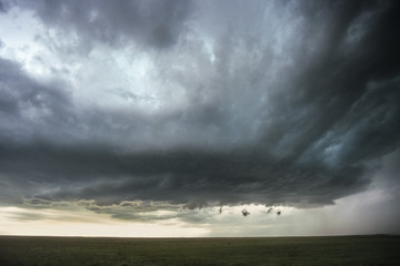 Dramatic view of a rotating wall cloud of a supercell thunderstorm over the high plains of eastern...