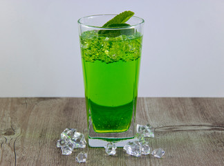 A glass of nutritious estragon drink to maintain a healthy lifestyle. Were added to the drink ice.