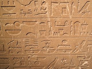 Ancient Egypt tomb hieroglyphs stone wall background