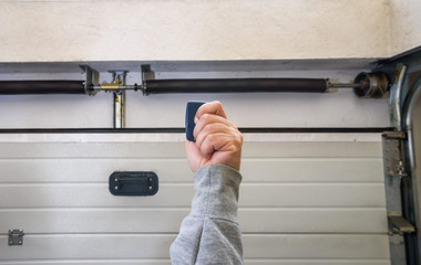 Garage door PVC. Hand use remote controller for closing and opening garage door.