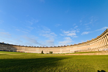 The Royal Crescent is a row of 30 terraced houses laid out in a sweeping crescent in Bath, England. It is among the greatest examples of Georgian architecture in the UK. Afternoon of a sunny day