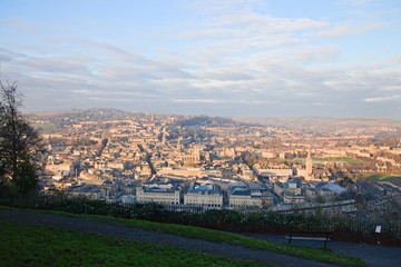 Fototapeta premium Aerial view on Bath old town at sunset from Alexandra Park, cloudy blue sky. Somerset, England