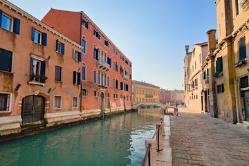 Fototapeta na wymiar Typical view of the old city of Venice, Italy, with canals, bridges, ancient buildings immersed in water, boats and gondolas