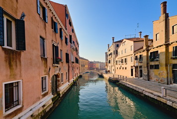 Fototapeta na wymiar Typical view of the old city of Venice, Italy, with canals, bridges, ancient buildings immersed in water, boats and gondolas