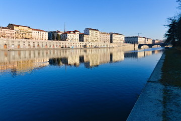 Obraz premium Po riverside in a bright spring morning with a blue sky, bridges and reflections on the water surface, Turin, Piedmont, Italy