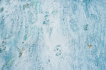 cracked old turquoise and blue paint on a wooden background