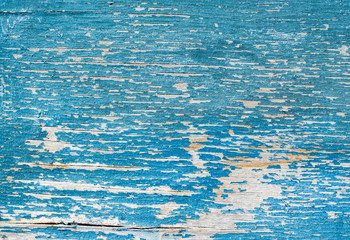 cracked old turquoise and blue paint on a wooden background