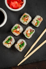 Japanese sushi on a rustic dark background.