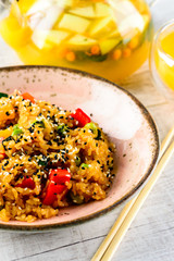 Asian cuisine - Tori tyahan. Fried rice with chicken meat, vegetables and radishes in bowl.