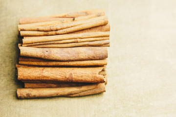 a bunch of whole sticks of fragrant cinnamon on a wooden rural table. copyspace. composition of...