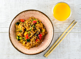 Tyahan - fried rice with chicken and vegetables in a bowl on the table