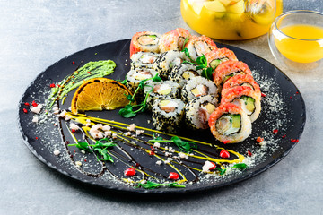 asian sushi set on wide plate, ready meal to eat, seafood