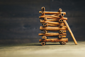 tower of whole sticks of fragrant cinnamon on a wooden rural table. copyspace. composition of seasoning and slide flavoring aromatic spice. close-up. side view, macro