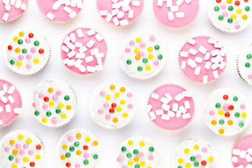 Colorful cupcakes on a white background.