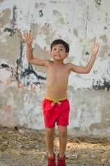 Little boy happily salutes us