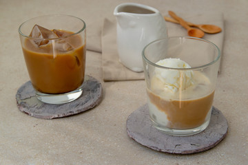  Iced coffee with ice cream and ice in glasses on the table.