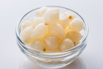 pickled vegetables on a white acrylic background