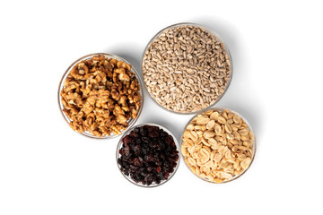 Sunflower seeds, salted peanut, walnut and raisins isolated on white background.