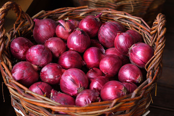 Red onions in a wooden basket. The spring avitaminosis.Vegetables in a basket, organic food and fresh vegetables
