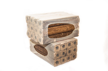 Fuel briquettes folded in rows on a white background. Wooden  briquettes are an environmentally...