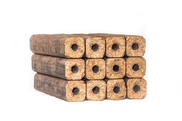 Fuel briquettes folded in rows on a white background. Wooden  briquettes are an environmentally friendly fuel source that are used to start a fire. They are made by pressing of dry sawdust.