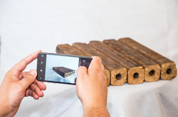 Fuel briquettes folded in rows on a white background. Wooden  briquettes are an environmentally...