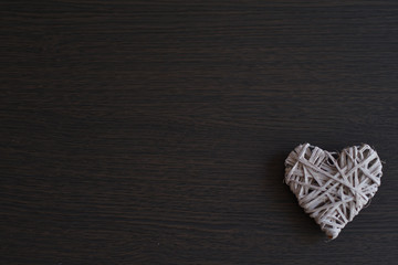 White wicker heart on wooden background, Love.